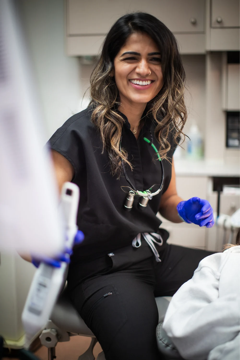Dr. Bhoomika Piplani seated beside a patient in the treatment room